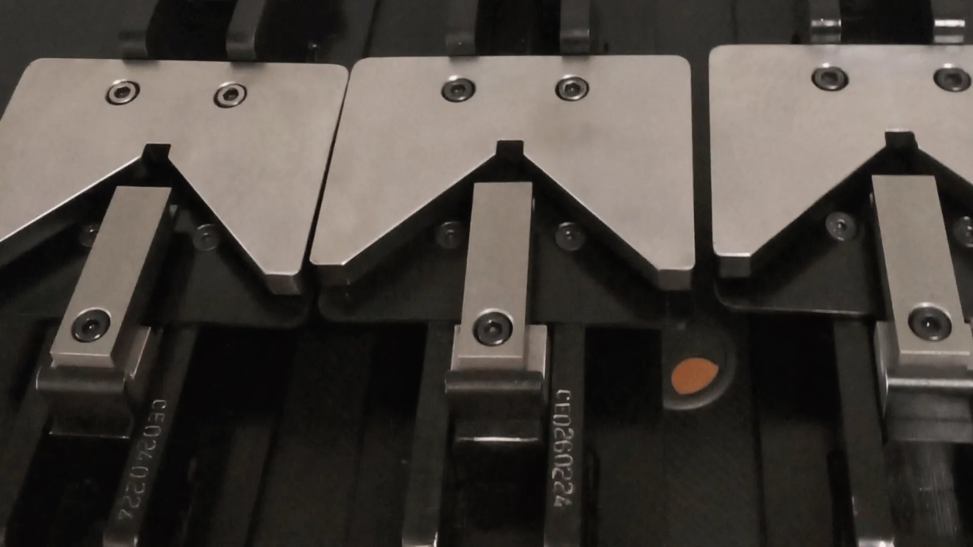 Close-up of metal press tools with visible branding on a black background. 28–30.5mm Joins—Aluminium Crimping Machine